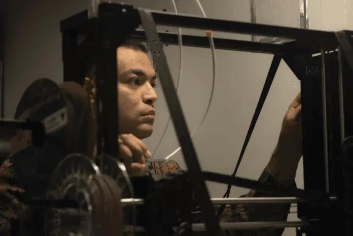a US Navy soldier operating a LulzBot 3D printer